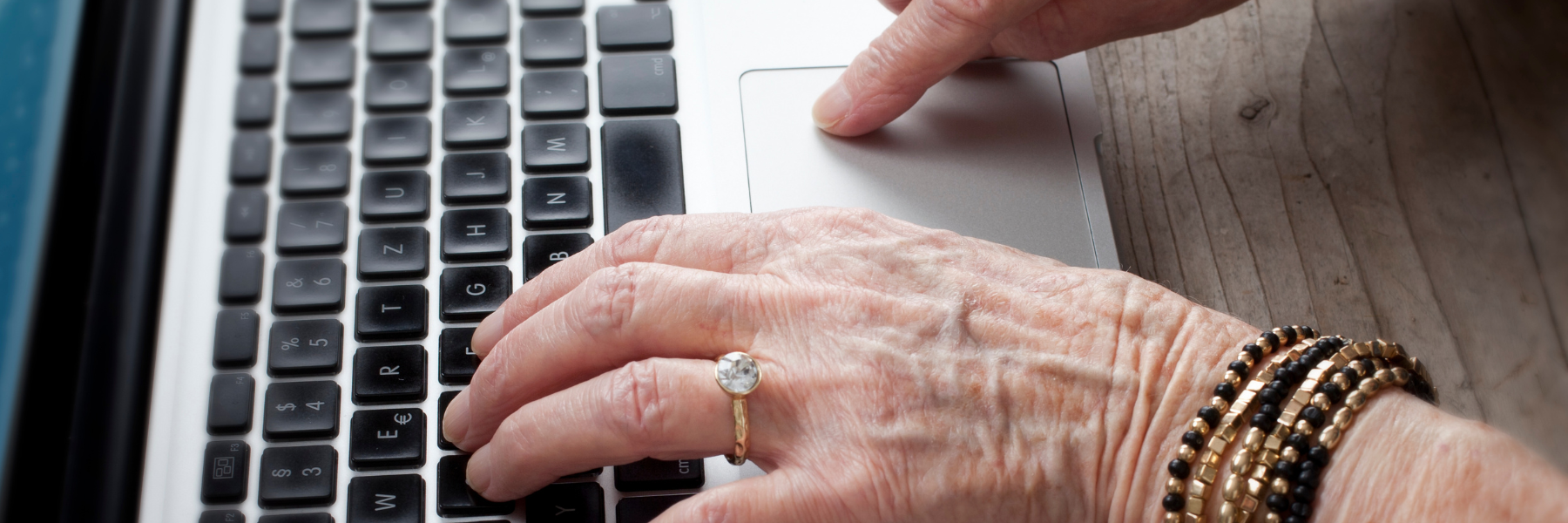 Older person typing on computer